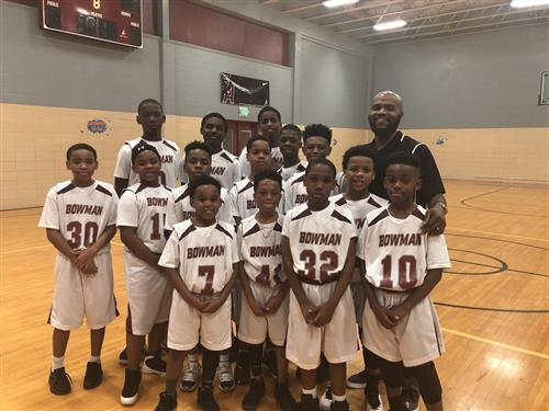 Thea Bowman elementary school basketball team posing in school gym.  